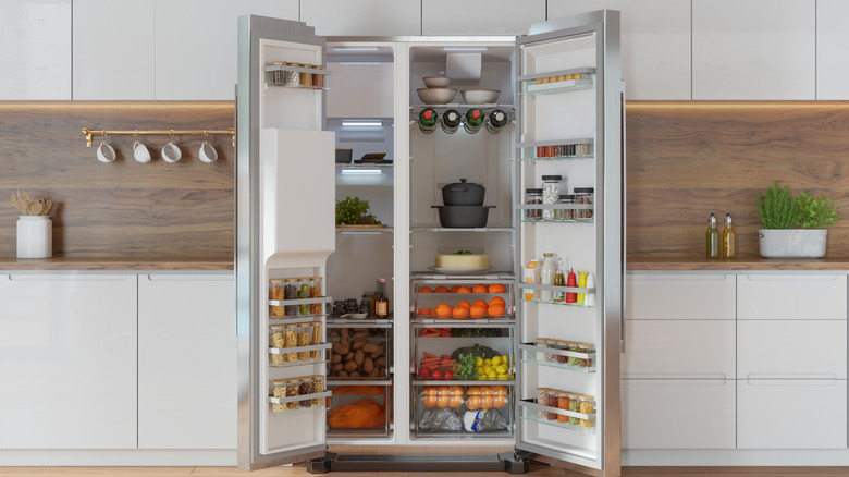 An open, neatly organized fridge filled with food.